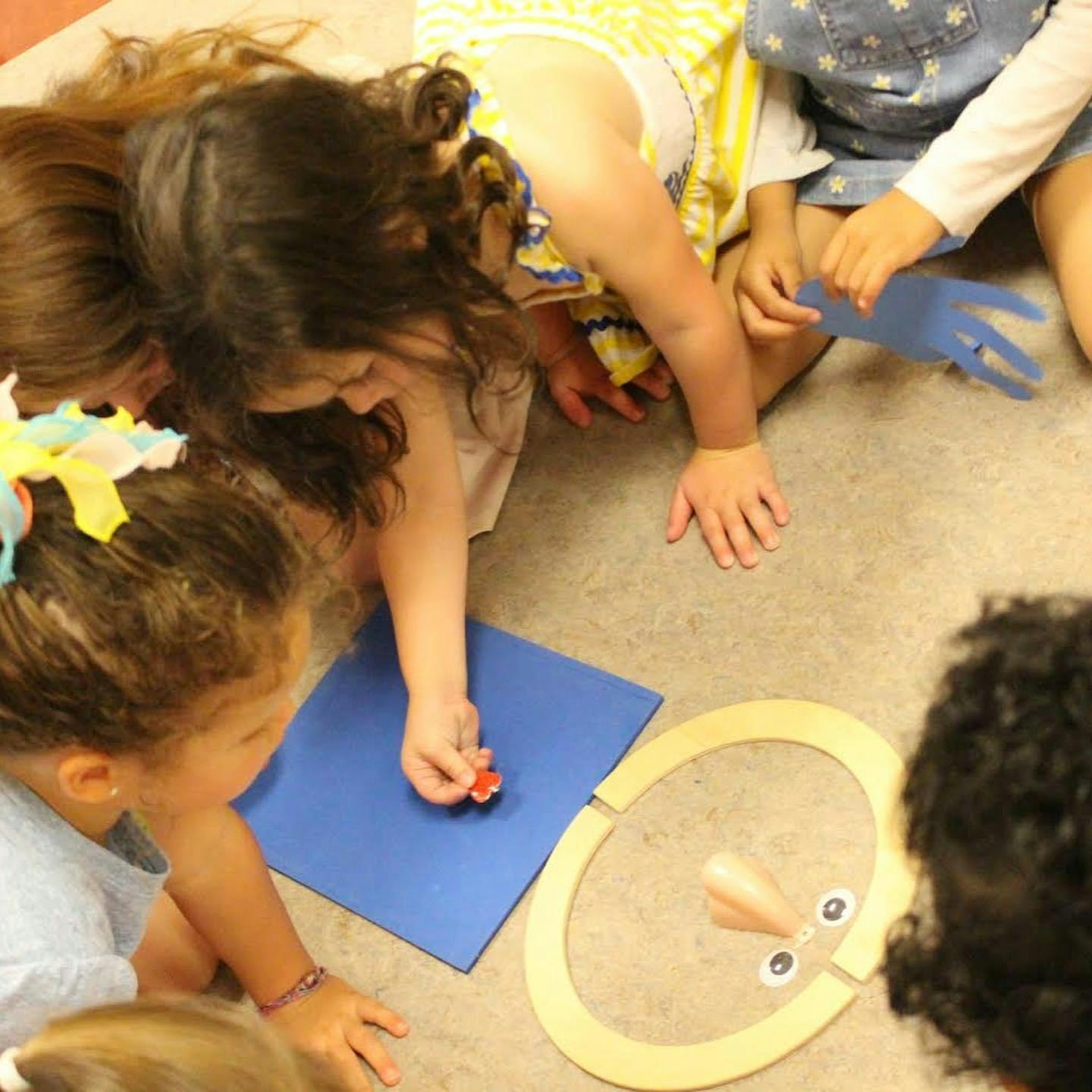 Children playing with craft materials on the floor