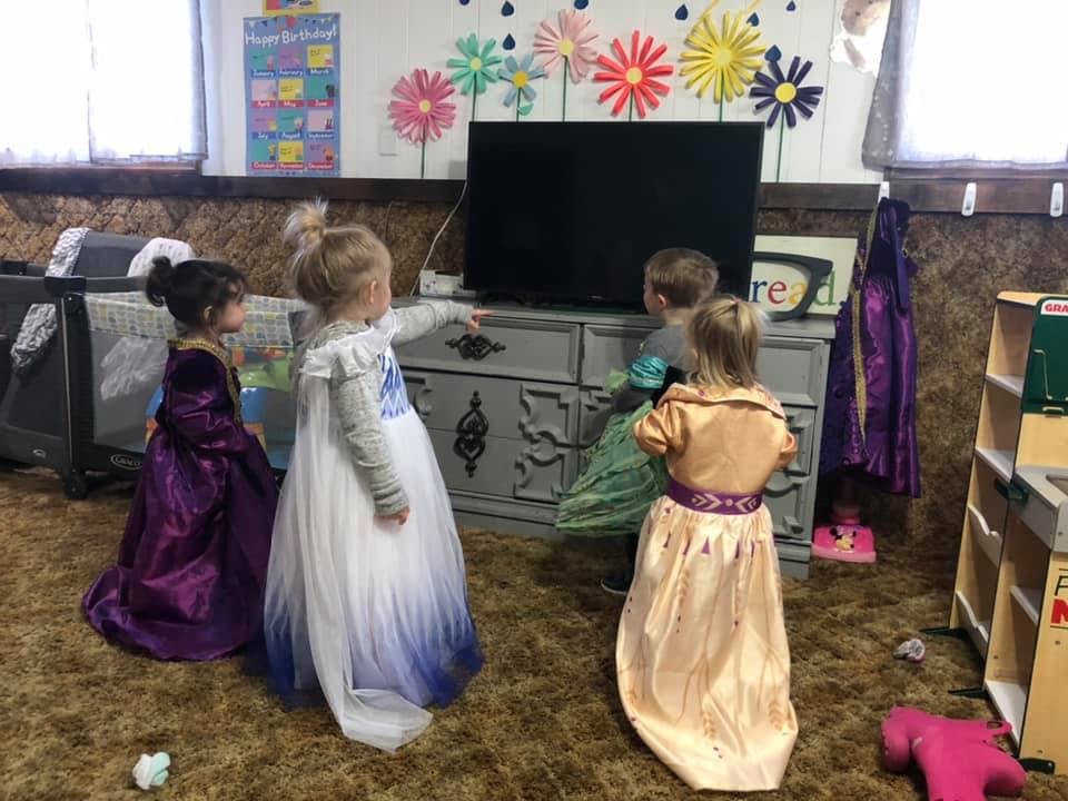 Children in costumes playing in a room