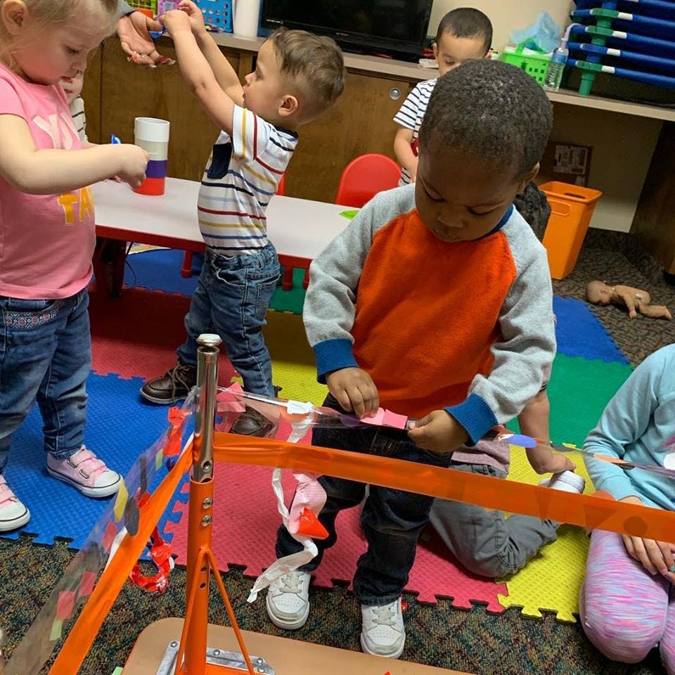 Children playing with toys in a classroom