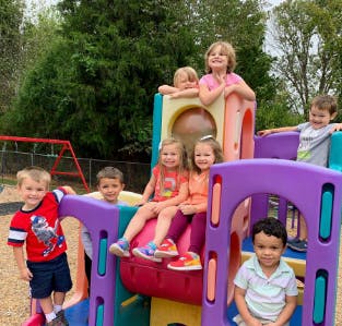 Children playing on a colorful playground structure