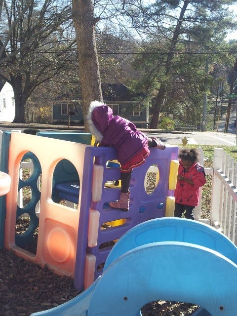 Child climbing on a playground structure
