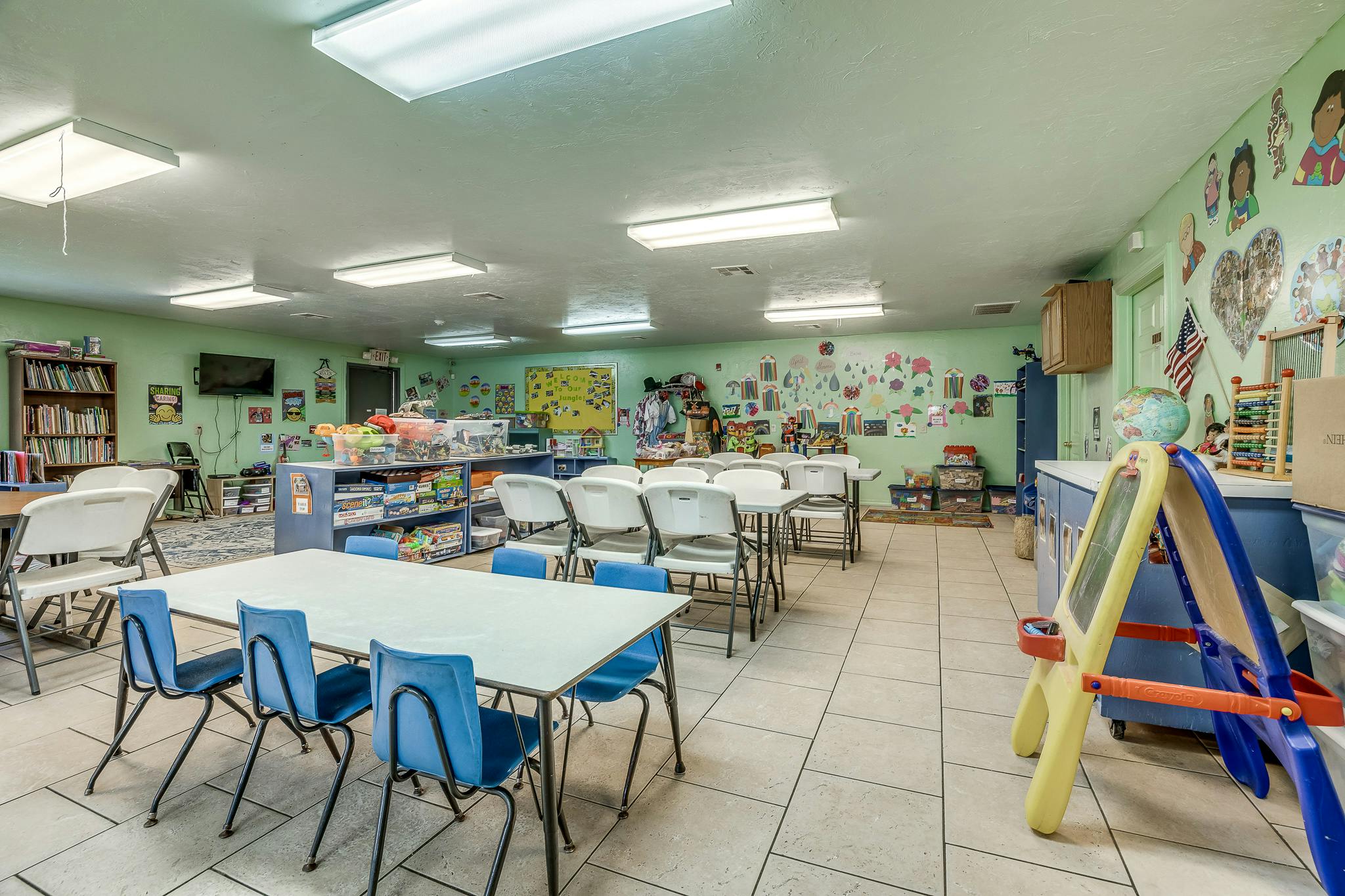 Classroom with tables and chairs, decorated walls