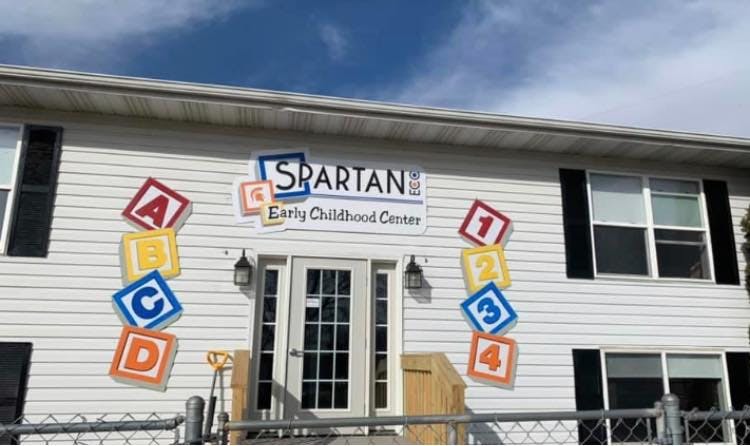 Building exterior with Spartan Early Childhood Center sign and alphabet blocks