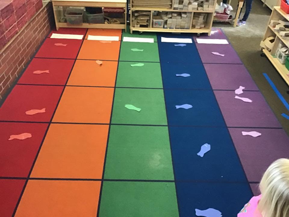 Rainbow colored floor tiles with fish shapes