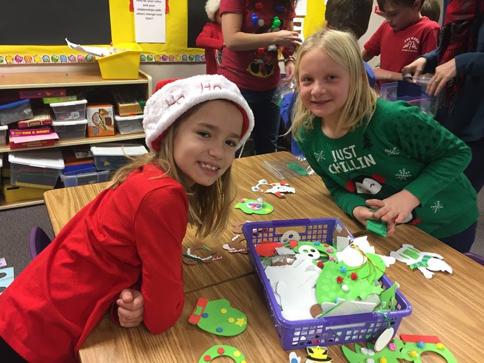 Two children at a table with crafts