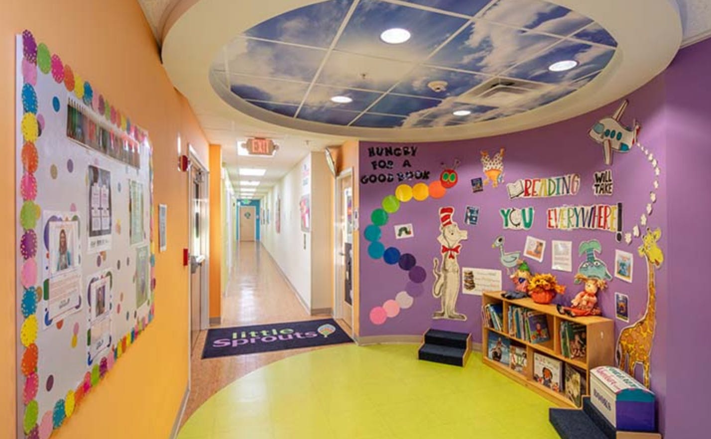 Hallway with colorful walls and a bulletin board