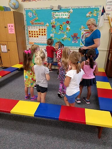 Adult and children gathered in a classroom