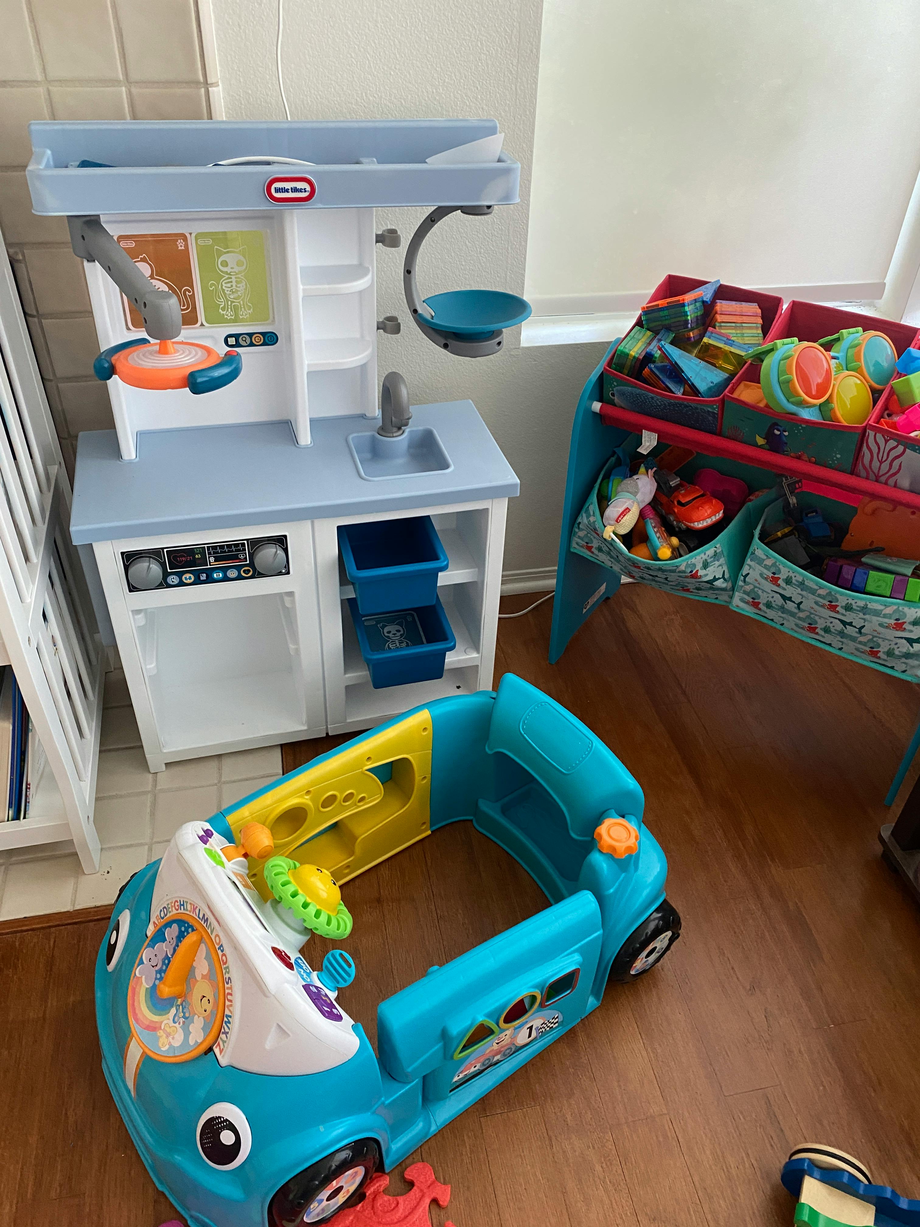 Play kitchen, toy storage, and blue toy car