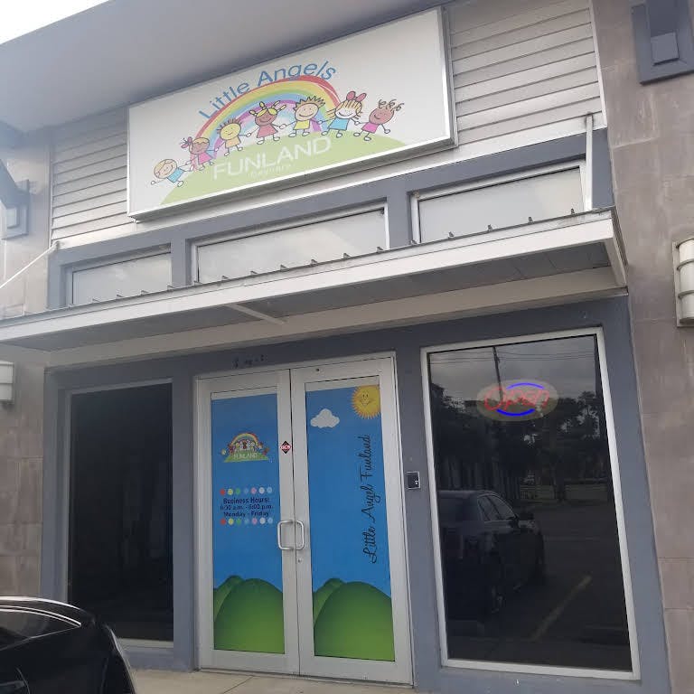 Building exterior with a sign that reads "Little Angels Playland"