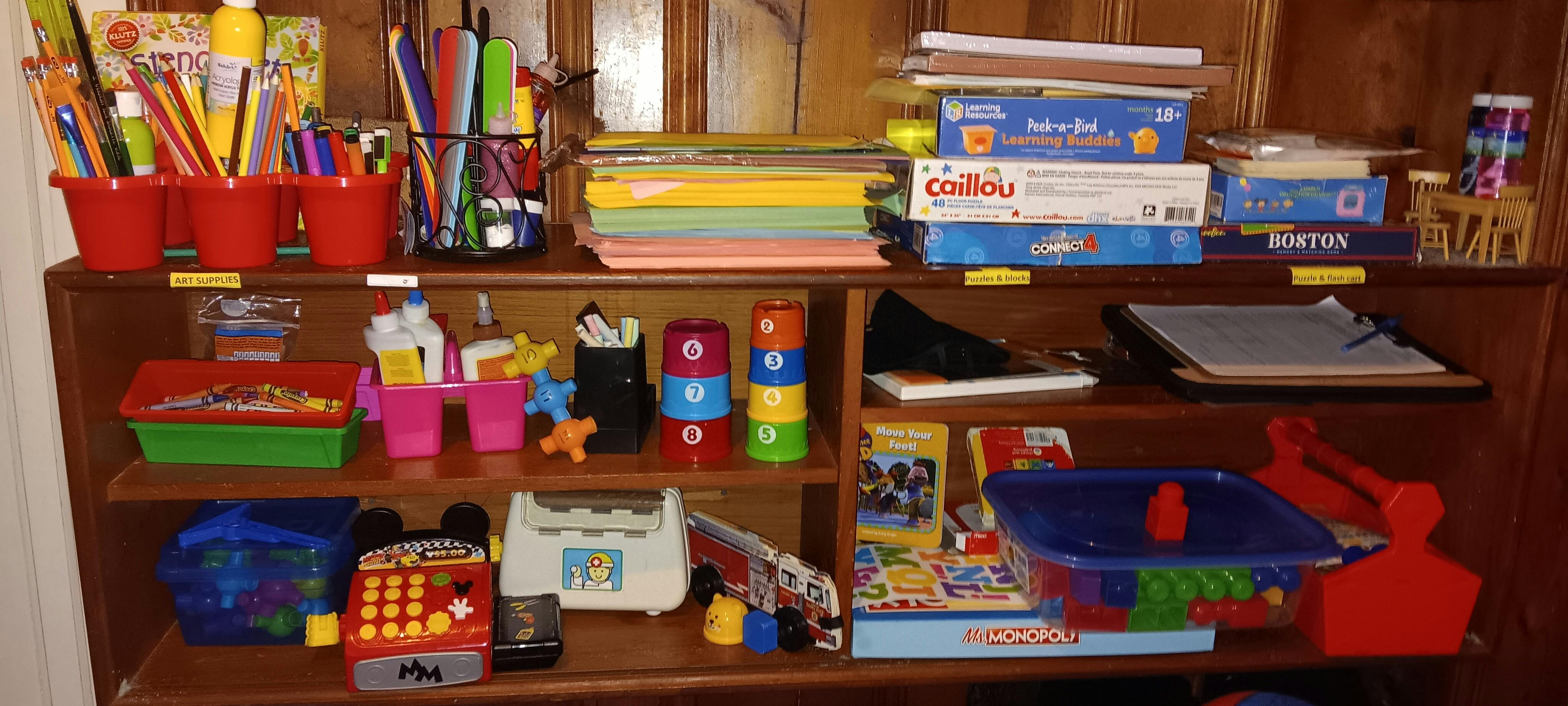Shelves filled with art supplies, games, and toys
