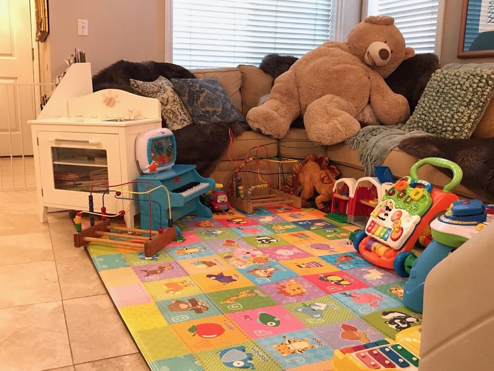 Playroom with a colorful alphabet mat and various toys
