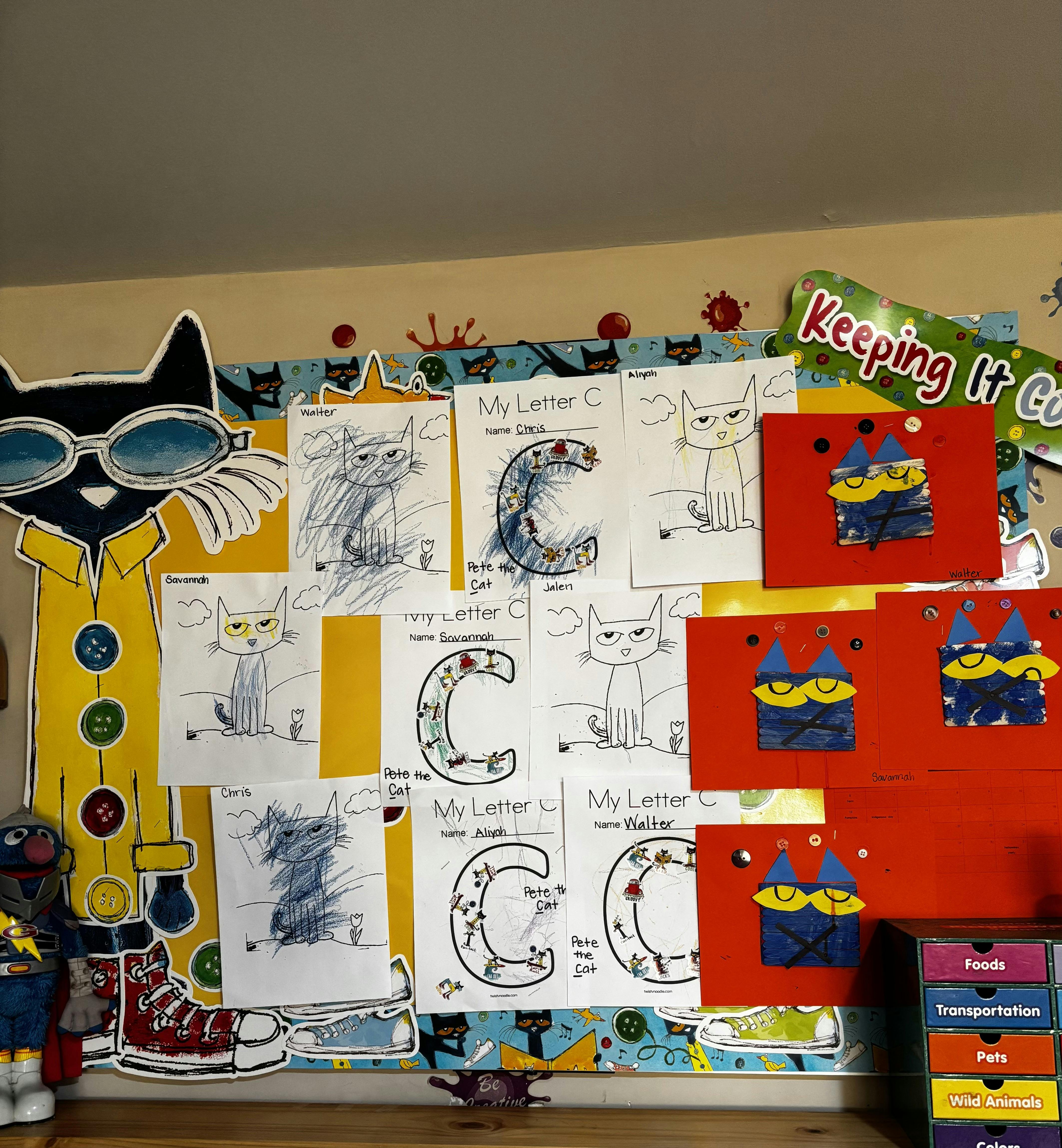 Classroom bulletin board featuring children drawings of Pete the Cat
