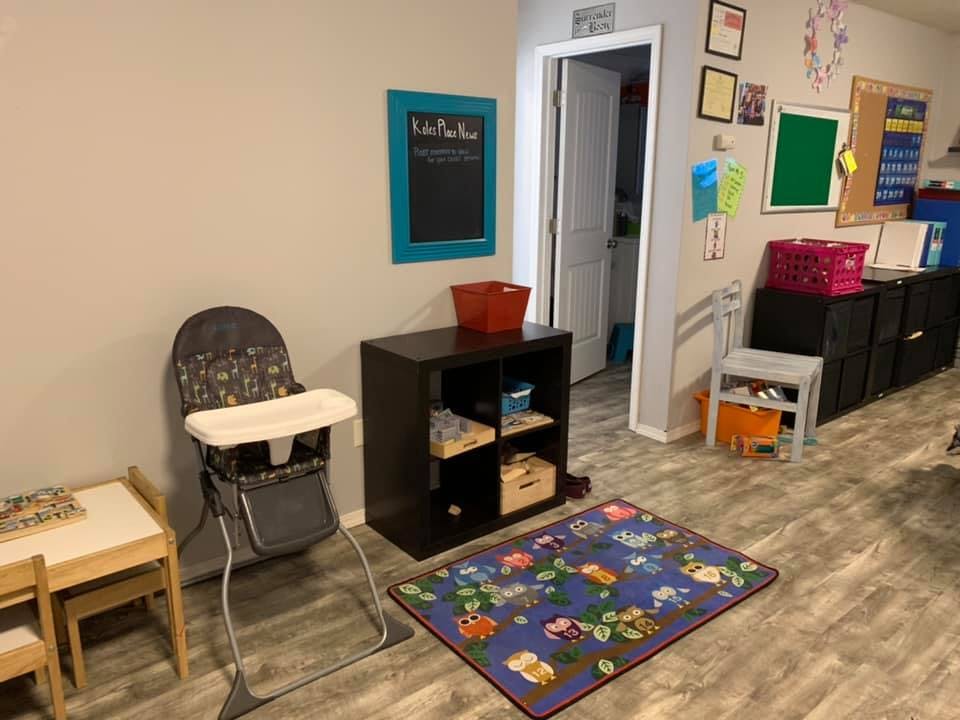 High chair next to a small table and storage unit in a room