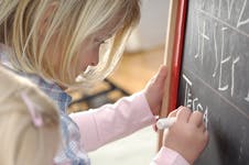 Child writing on a chalkboard