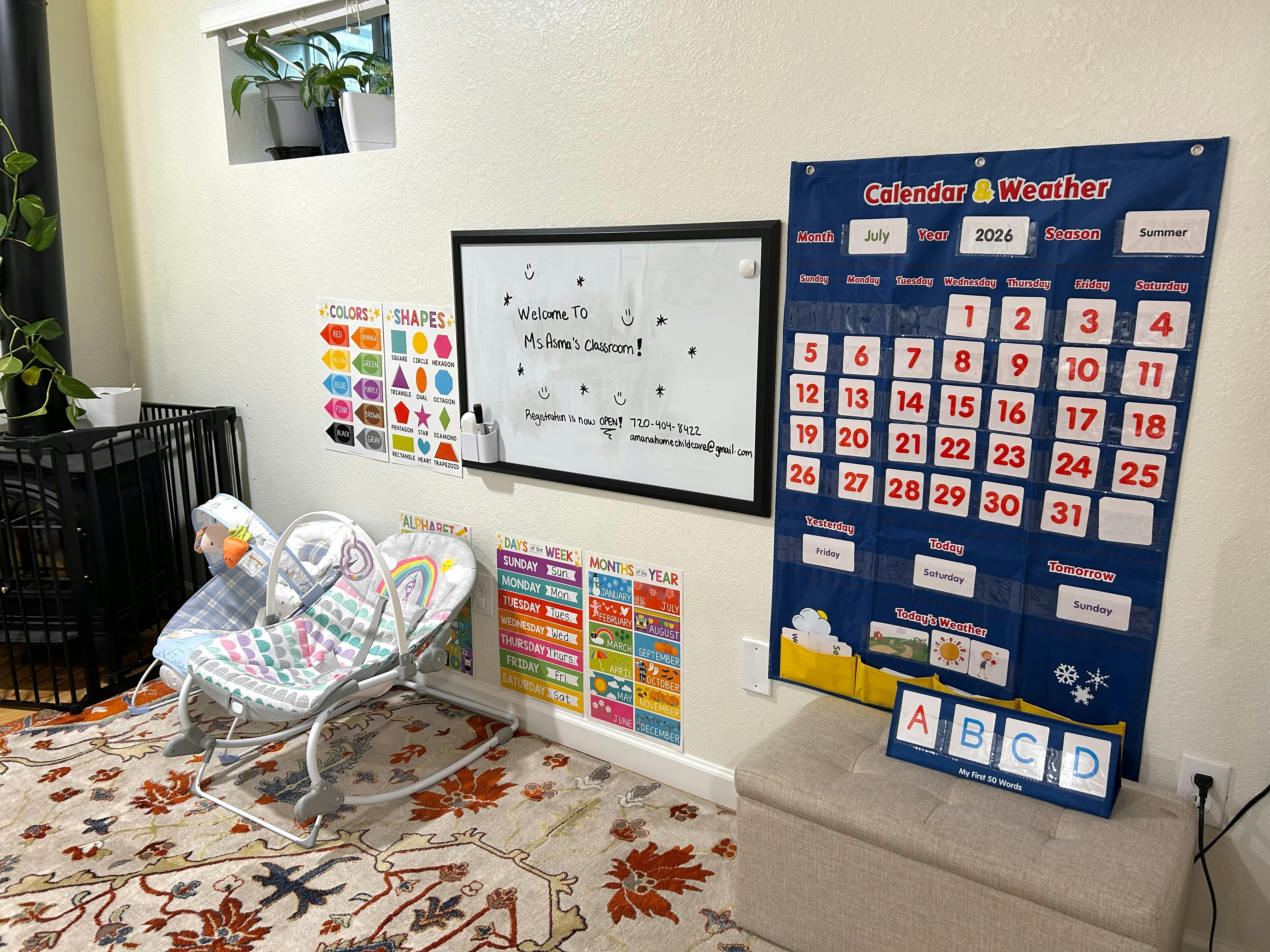 A classroom wall with a calendar, whiteboard, and educational posters