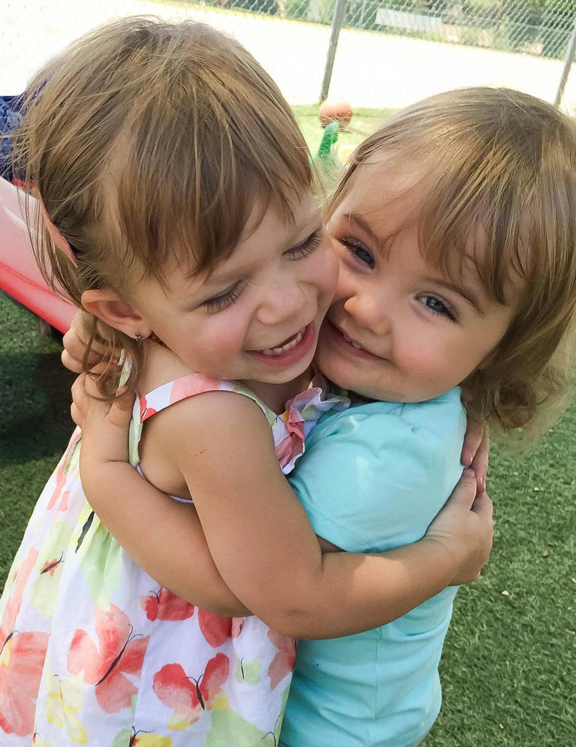two children hugging and smiling