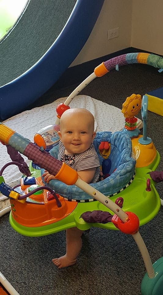 Child in a colorful baby activity center