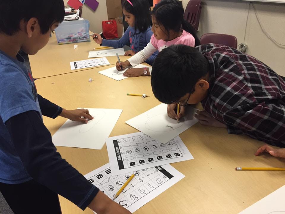 Children drawing and writing at a table