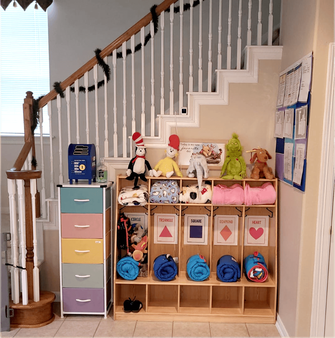 Staircase with a storage unit and colorful drawers underneath, stuffed toys