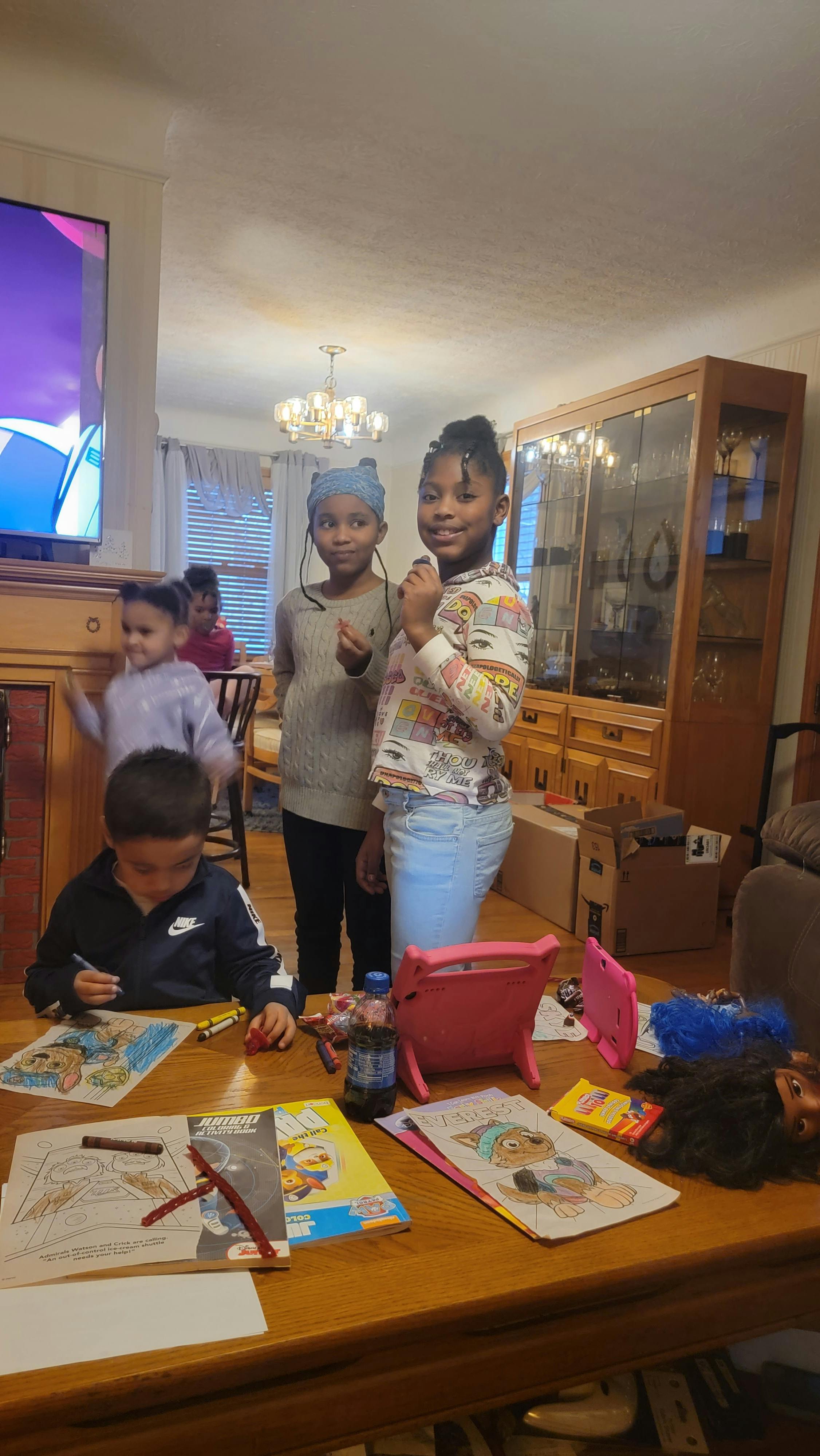 Children drawing and standing in a room