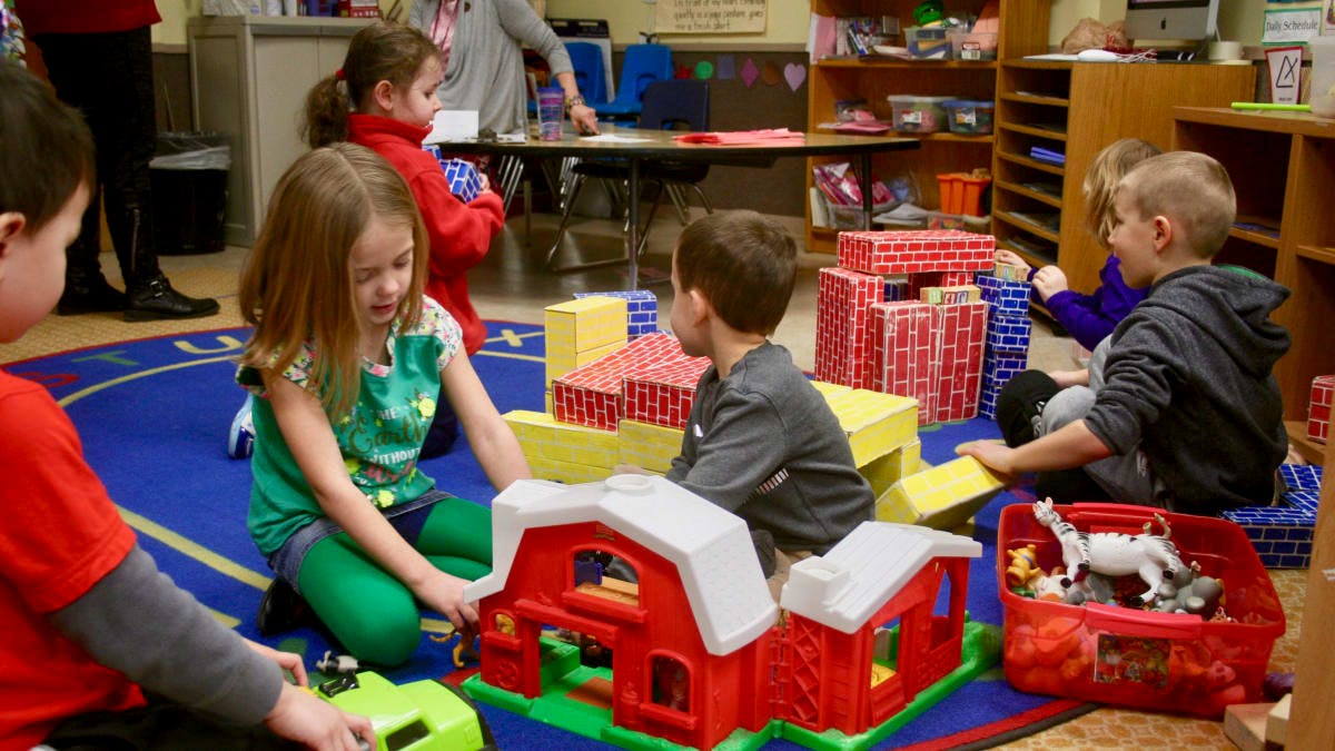 Children playing with toys in a classroom