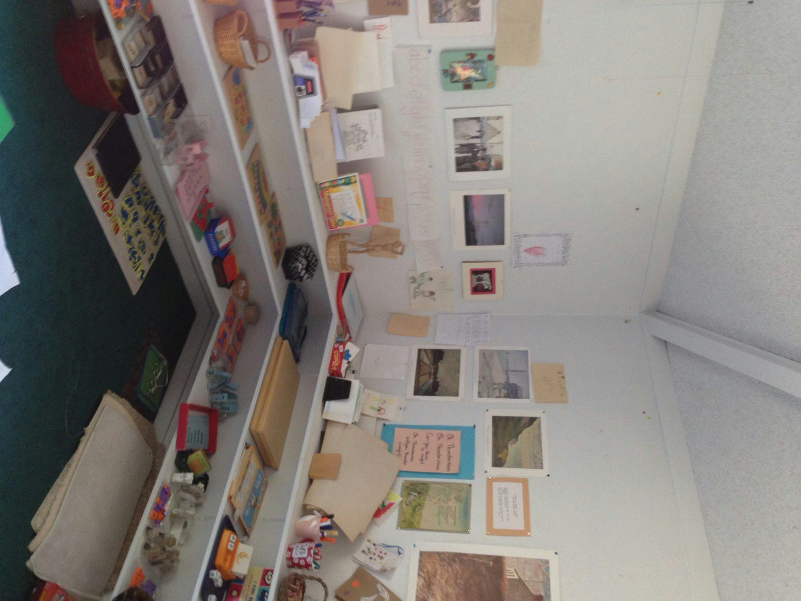 Shelves with various items and pictures on a wall