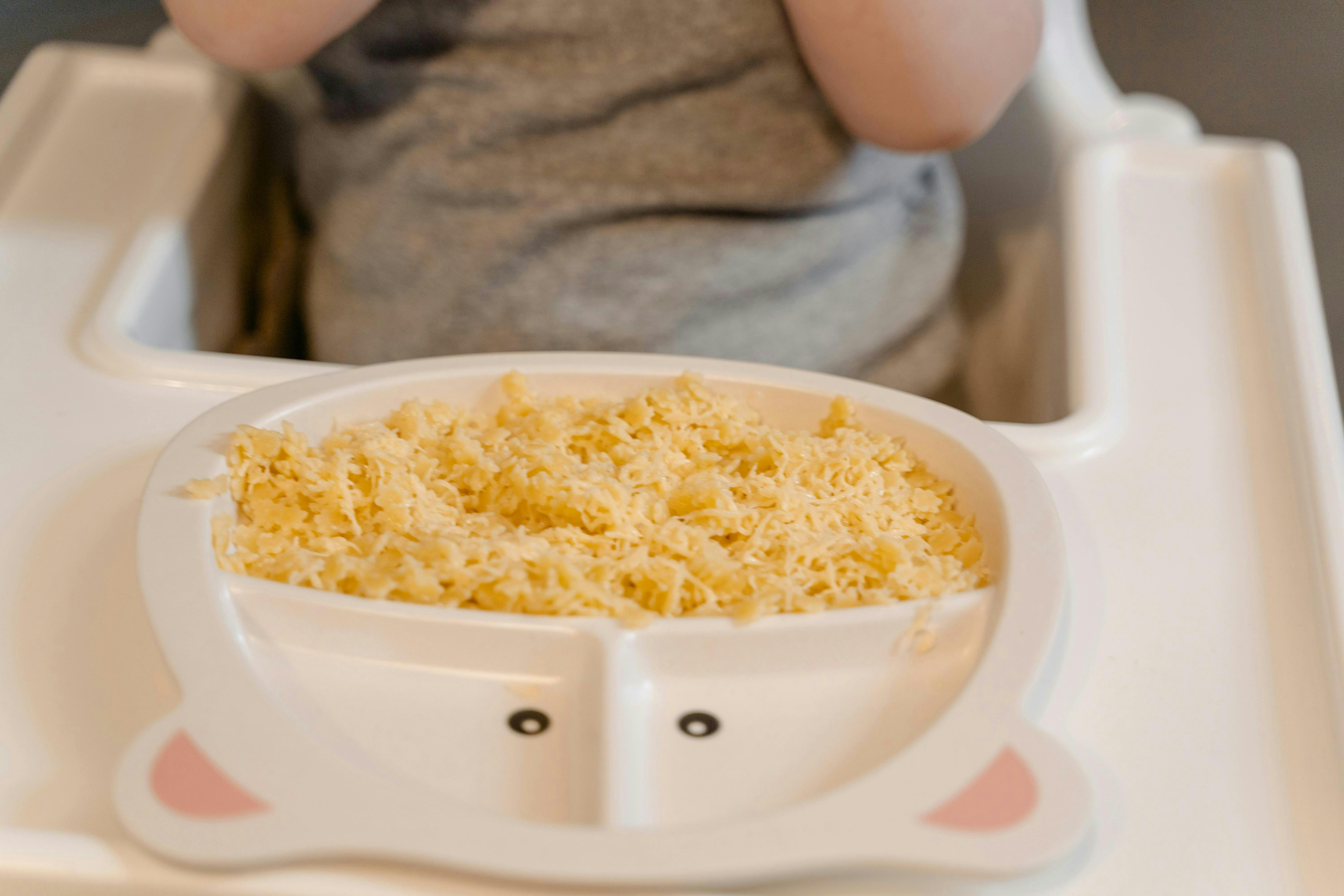Child in high chair with a plate of food