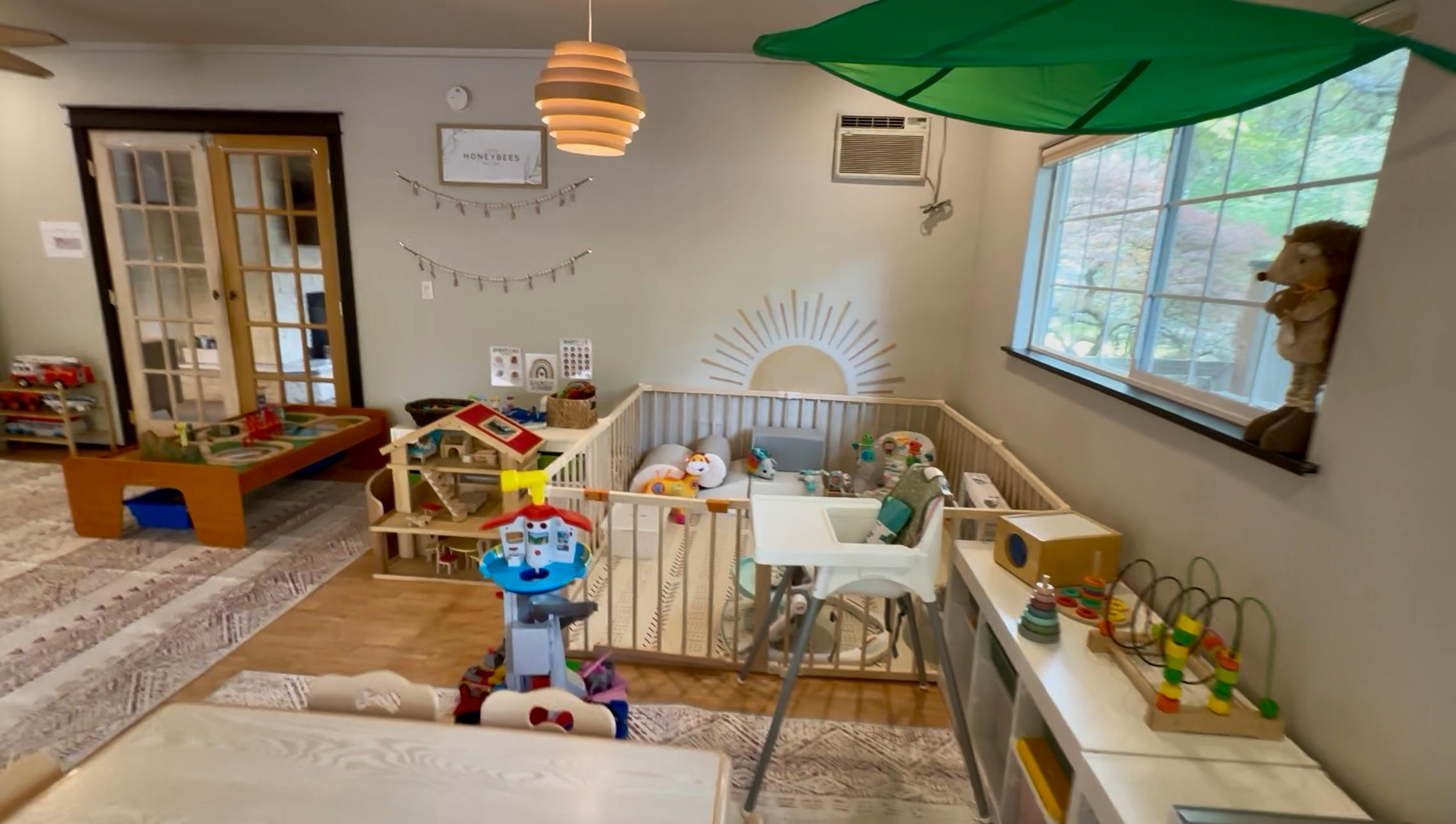 Indoor play area with a crib, toys, and a window