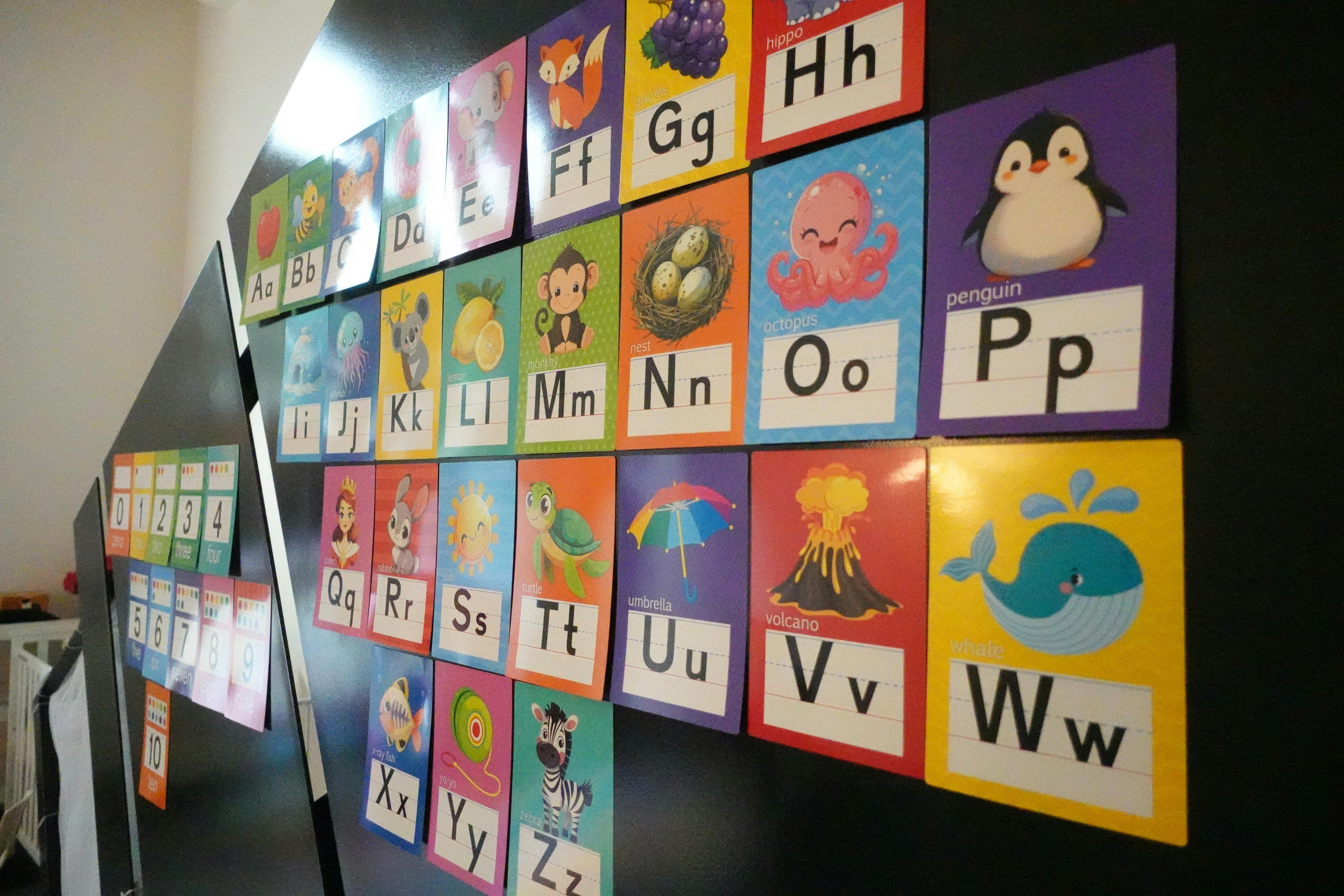 Alphabet flashcards and number cards on a dark surface