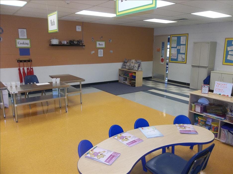 Classroom with child-sized tables and chairs and activity stations