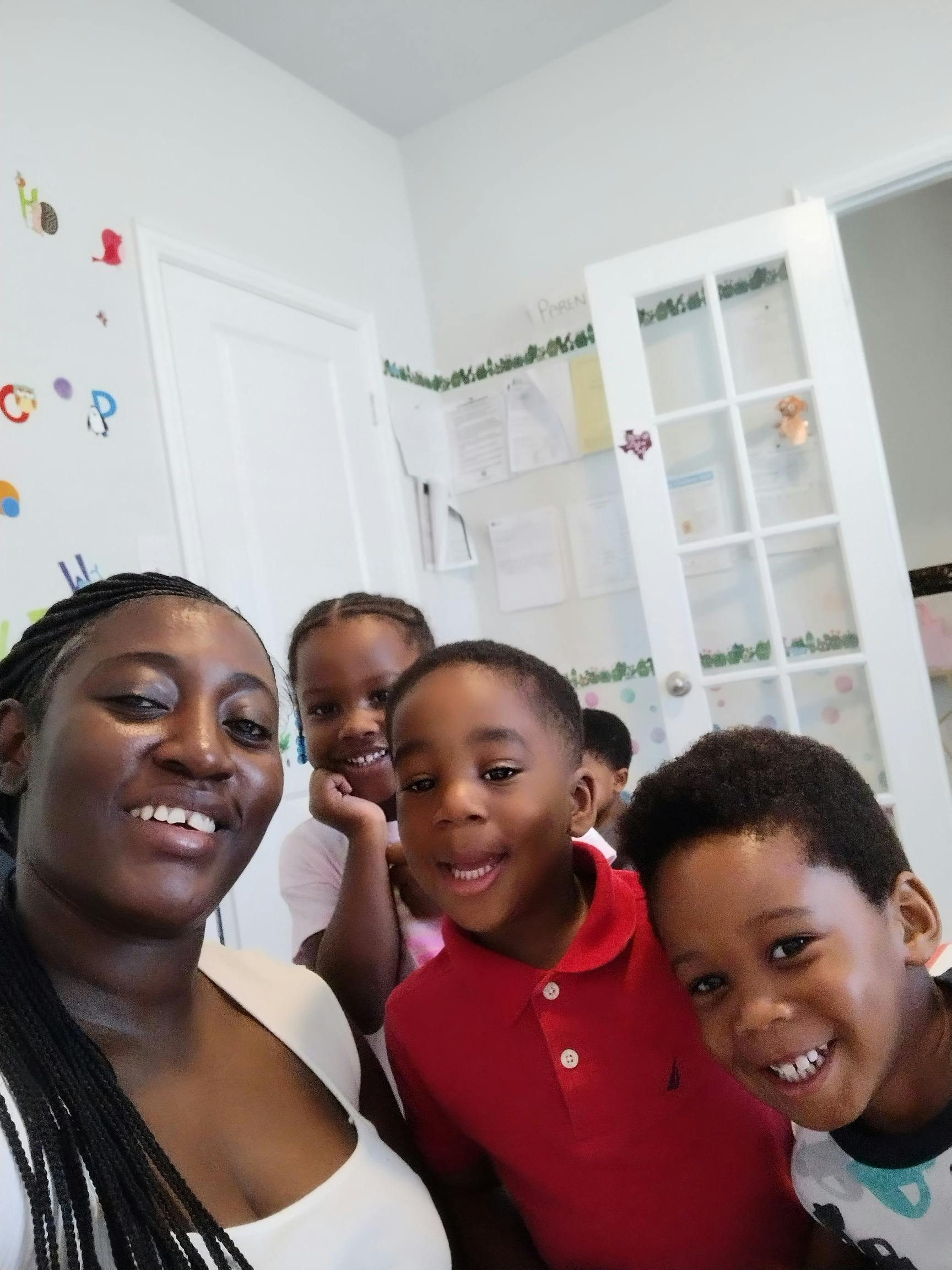 Person and three children smiling