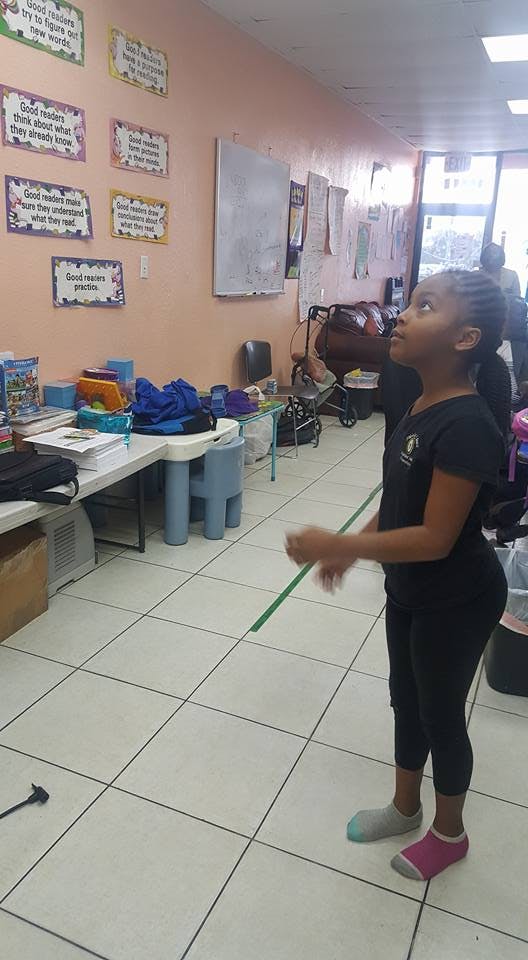 Child standing in a room looking up