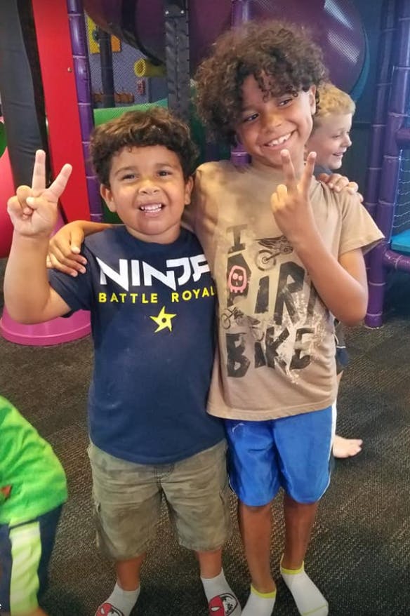 Two children making peace signs