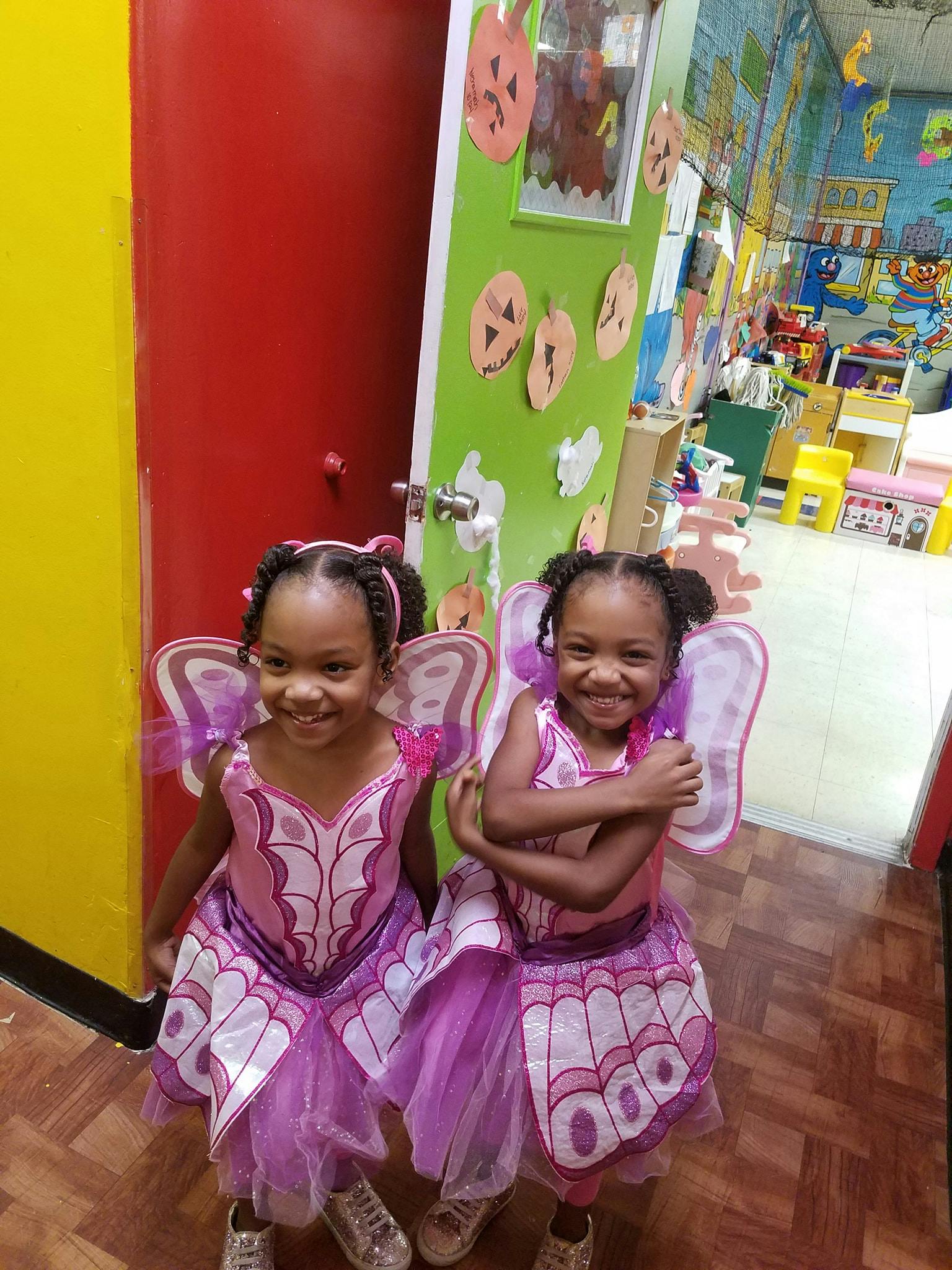 Two children in butterfly costumes with wings