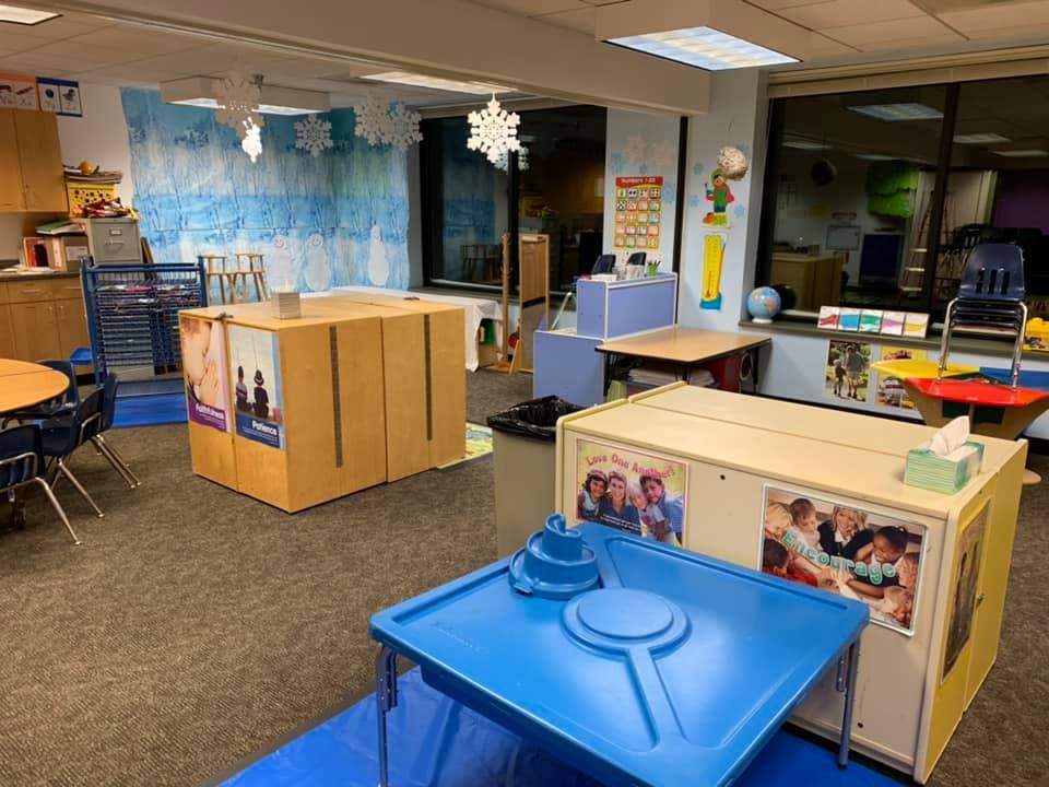 Classroom with tables, chairs, and blue and white wall decorations