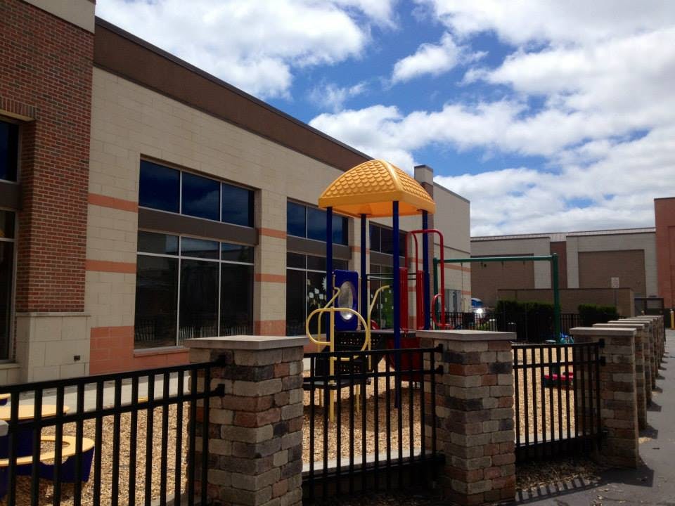 Playground with a yellow canopy next to a building