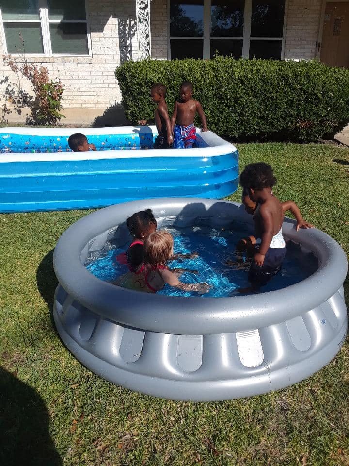 Children playing in inflatable pools outdoors