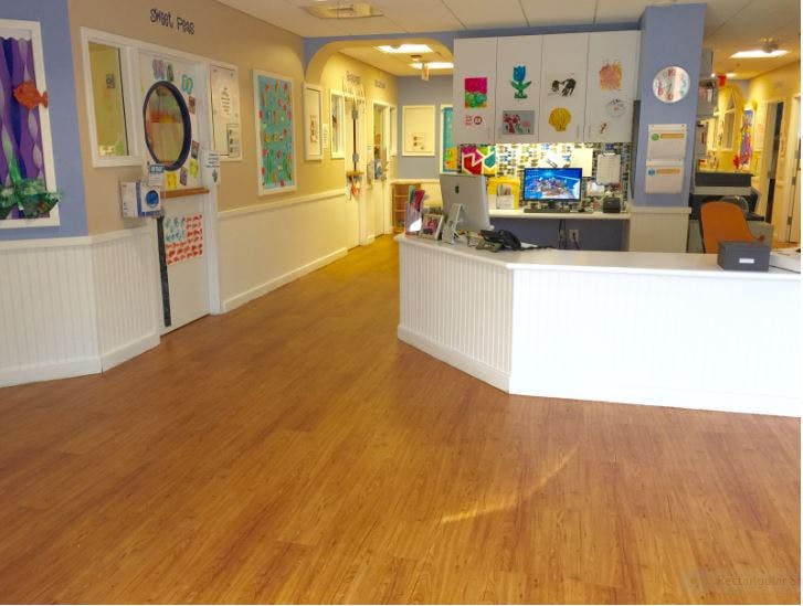Reception desk in a hallway with artwork on the walls