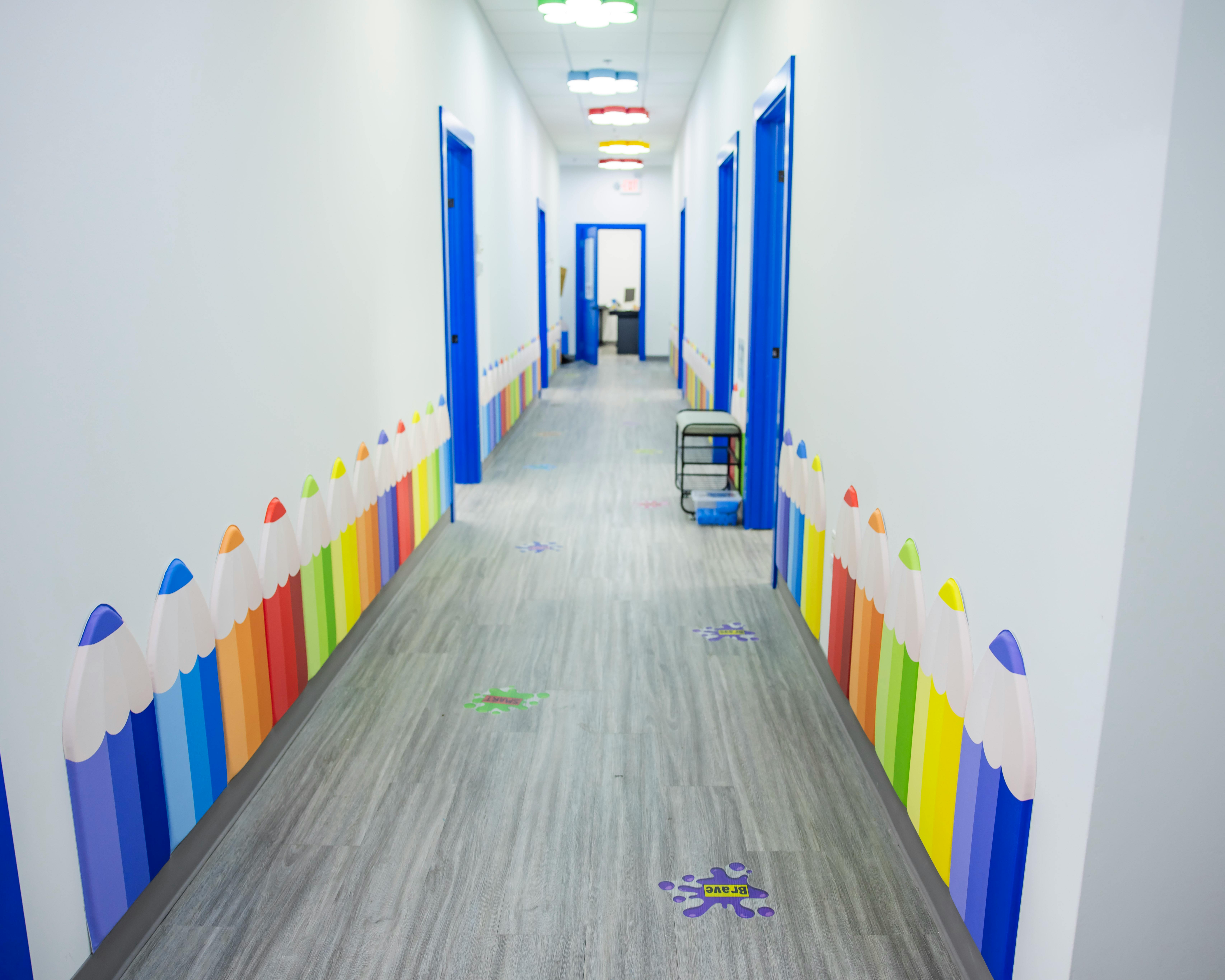 Hallway with blue doors and colorful wall decorations