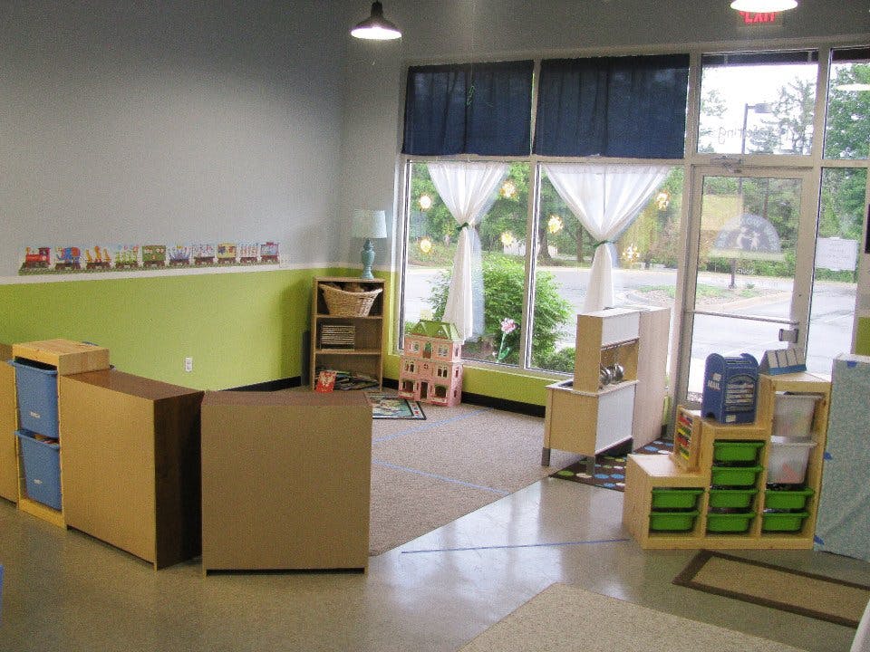 Empty classroom with large windows and various storage units