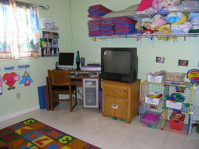 Desk with computer and chair in a room with a colorful rug