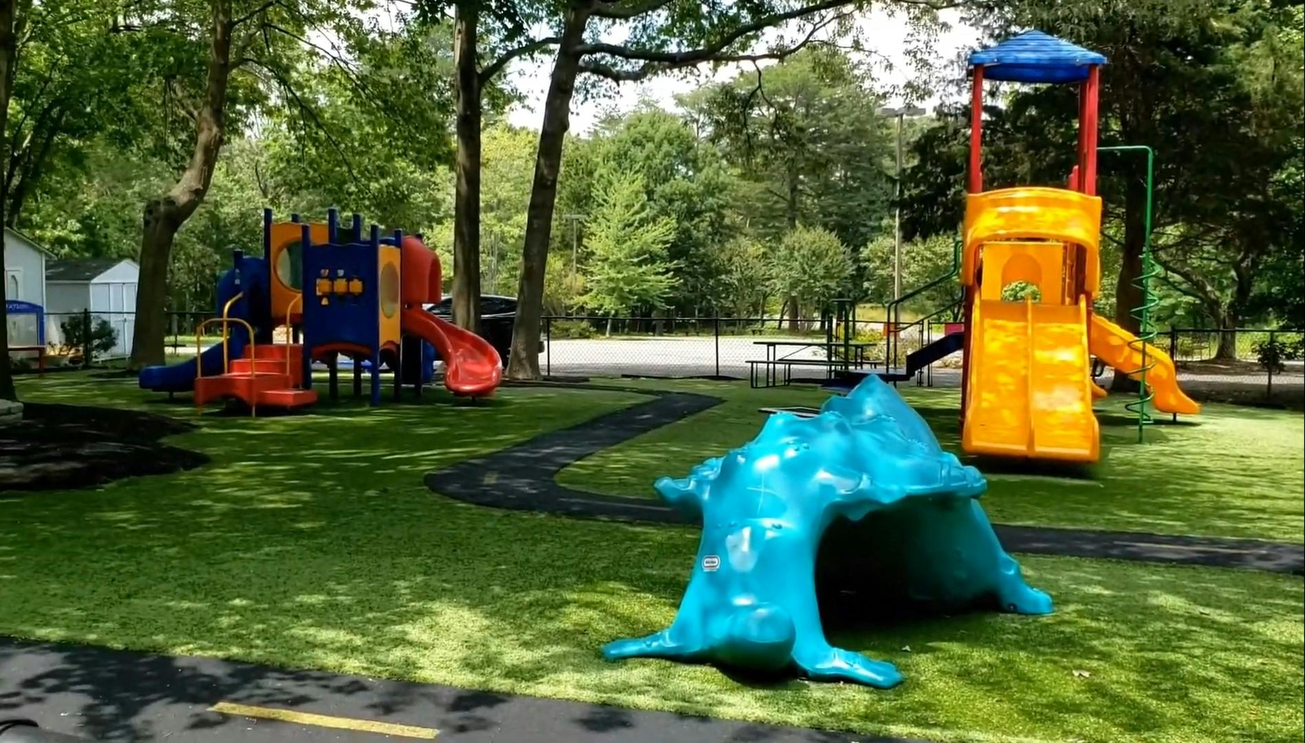 Playground with multiple colorful slides and climbing structures