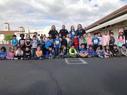 Group of adults and children posing outdoors