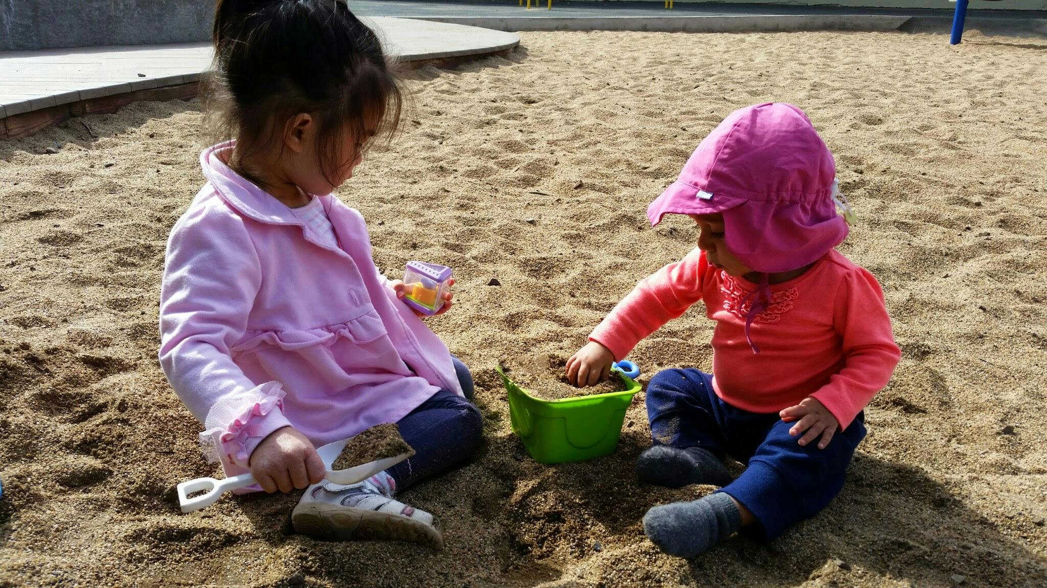 Two children playing in a sandbox