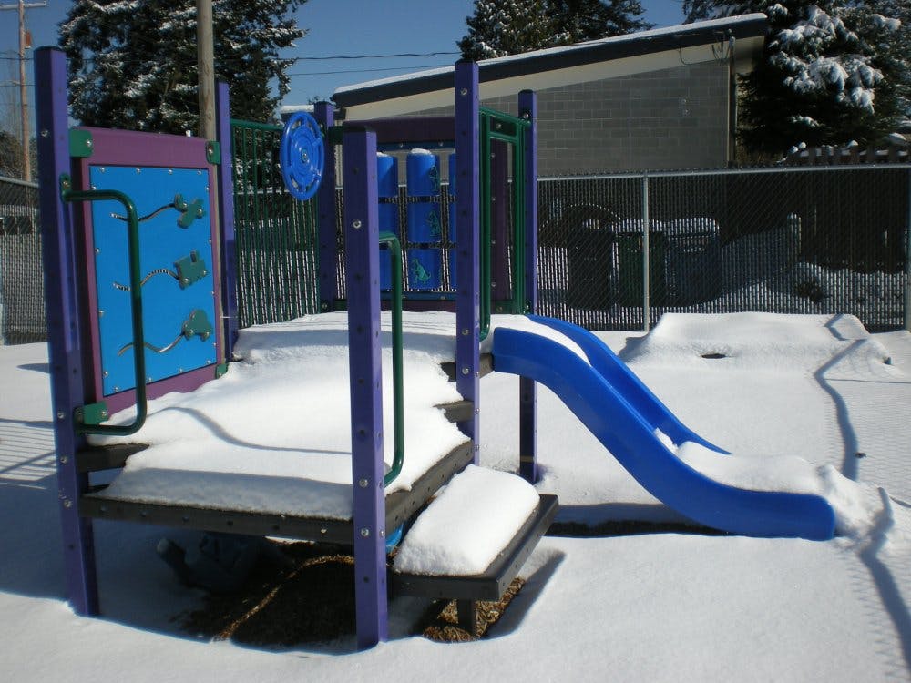 Playground equipment covered in snow