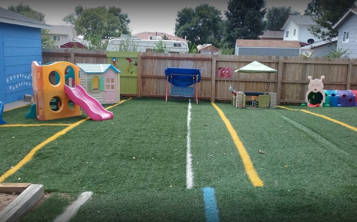 Playground with artificial turf, slide, and playhouses