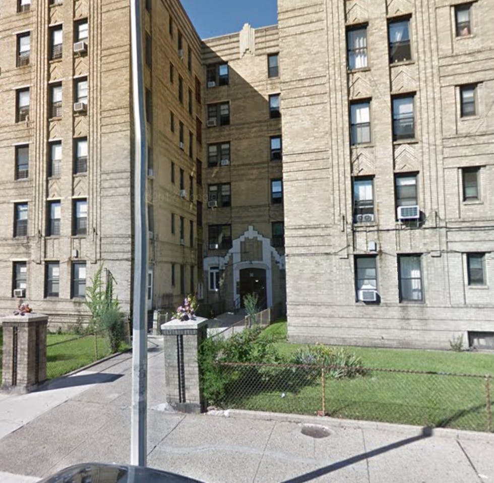 Exterior of a large brick apartment building with many windows