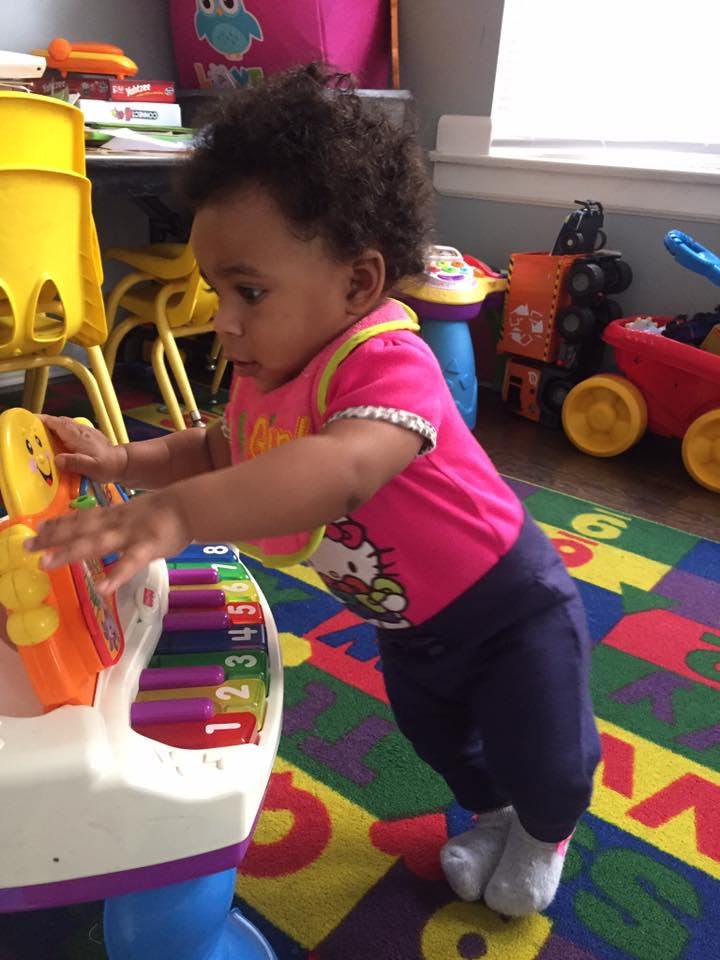Child playing with a toy piano