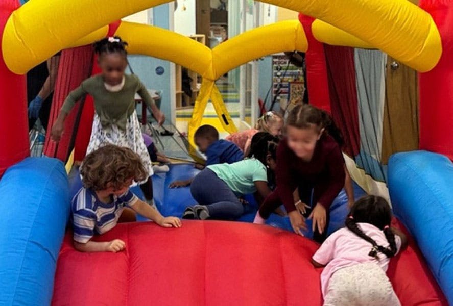 Group of children playing inside an inflatable bounce house