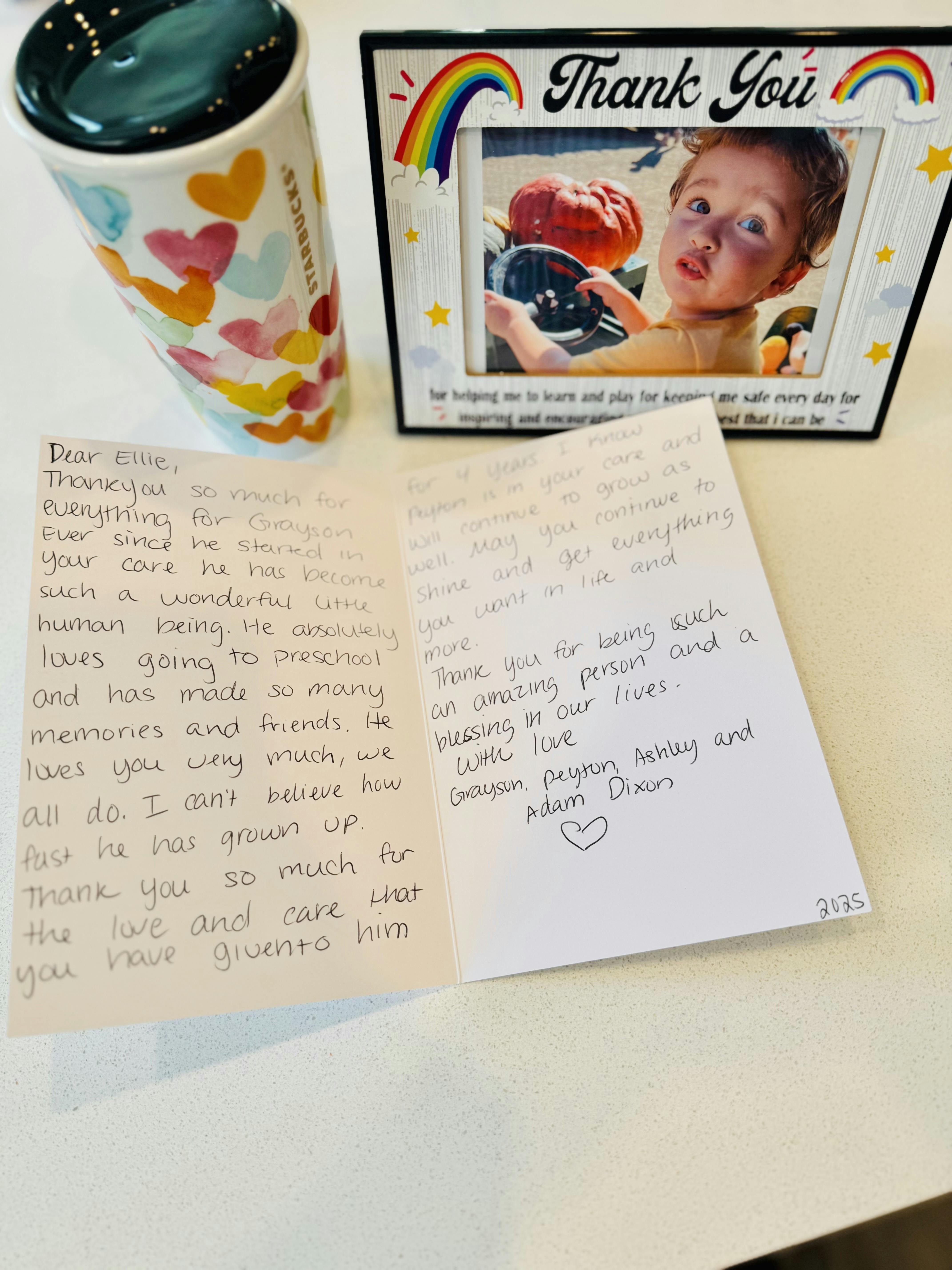 Thank You photo frame with a child's picture, a heart-patterned cup, and a card